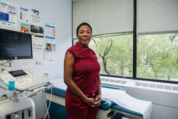 Dr. Tunde-Byass in hospital room standing before empty bed