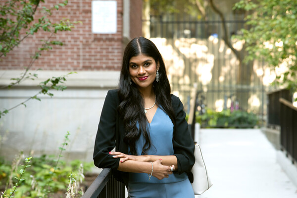 Portrait of Aditi Sivakumar, leaning on railing