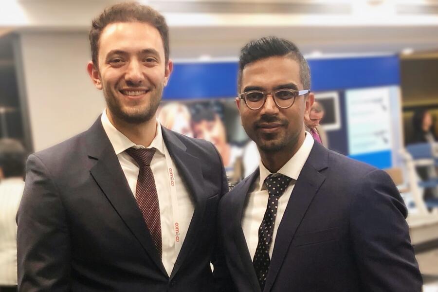 Dr. Zakhari with Dr. Murji at scientific research day, both smiling at camera
