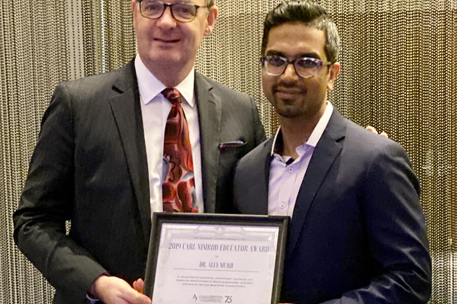 Dr. Kingdom presents award to Dr. Murji