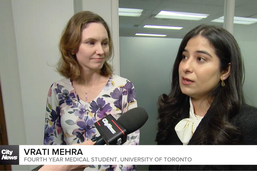 Screenshot of two researchers talking to reporter