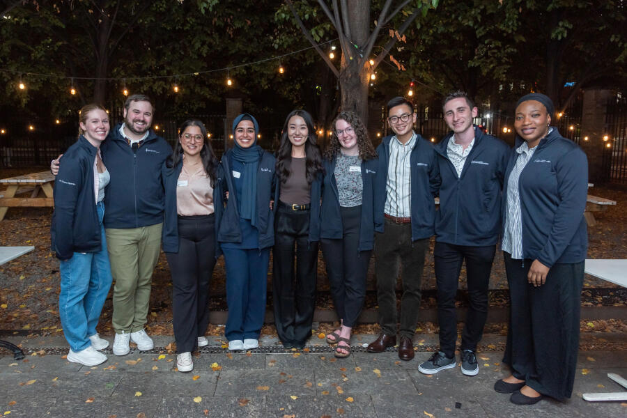 People in a row on outdoor patio