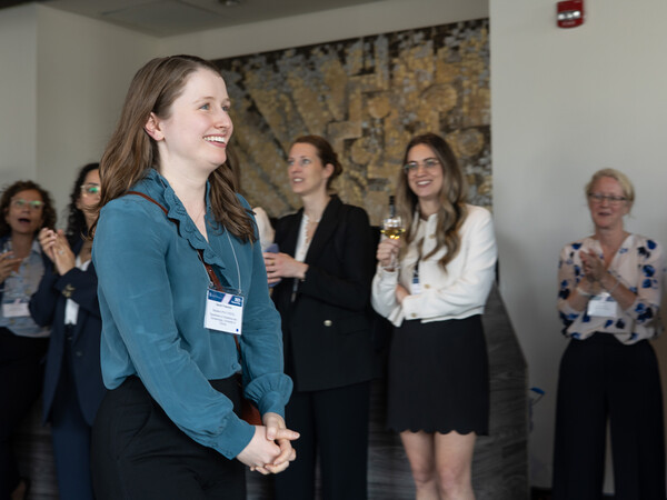 Woman smiling, walking up to receive her award