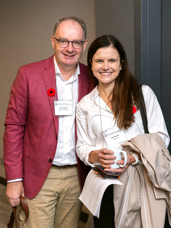 Man in red jacket beside woman holding coffee