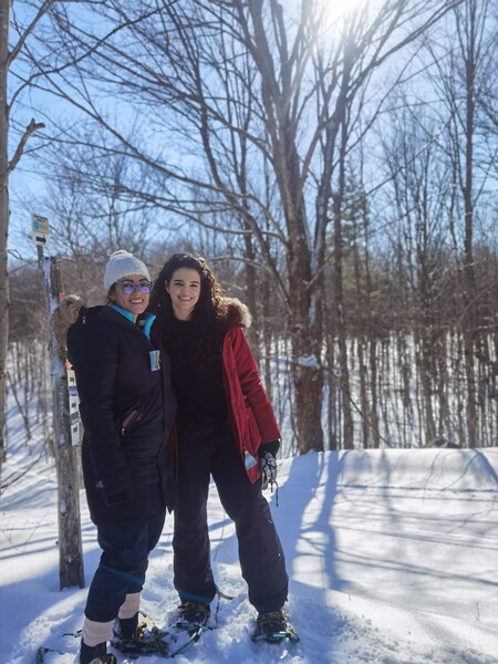 Two residents smile in the snow