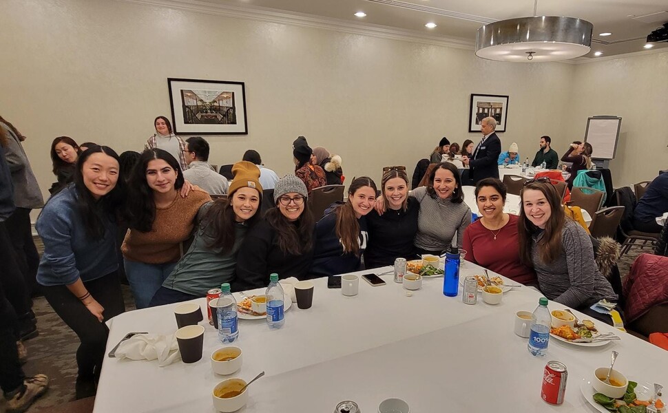Residents pose around the lunch table