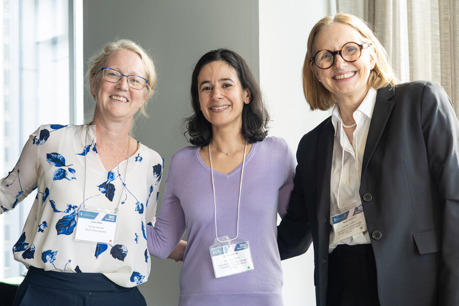Three women smiling for camera