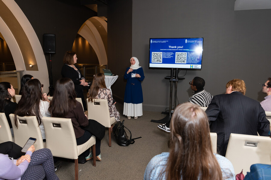 Woman making presentation in front of screen