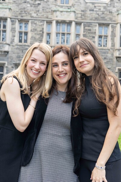 Three grads smiling