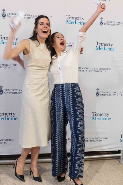 Two grads shouting with joy