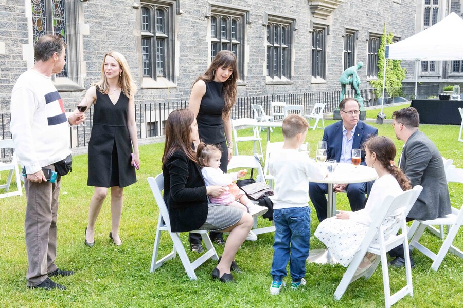 People with children on lawn, seated and standing