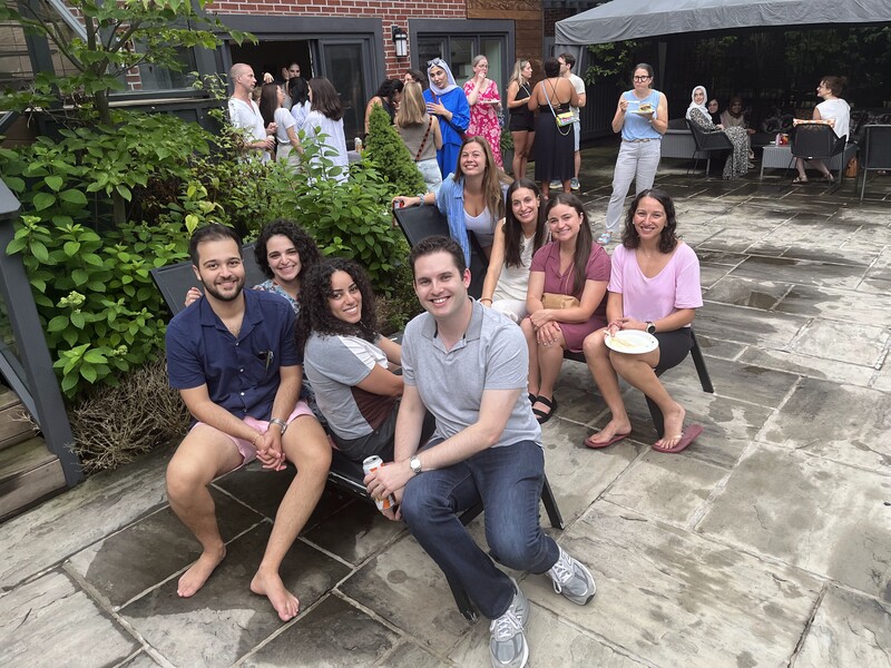 Seated residents smile by the pool