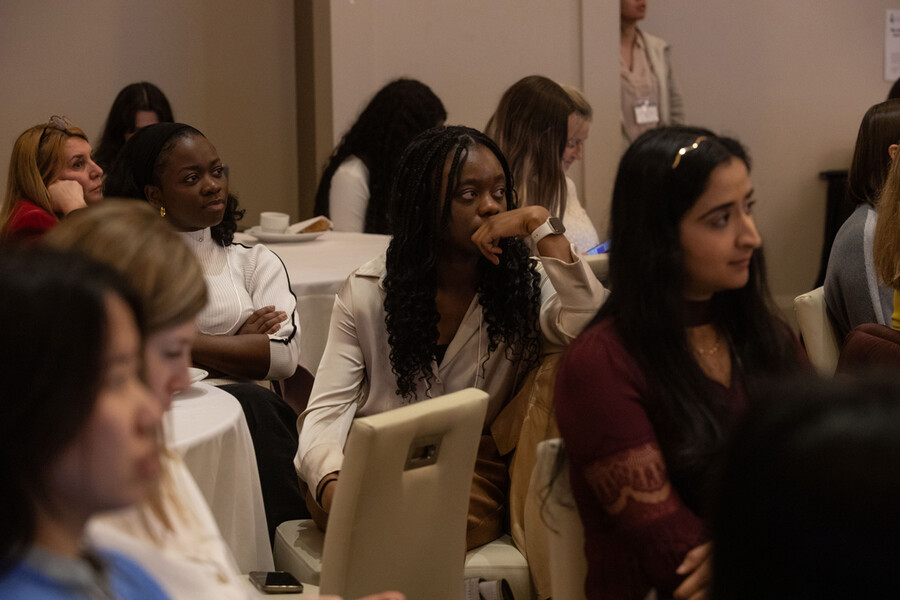 Seated people listening to presentation