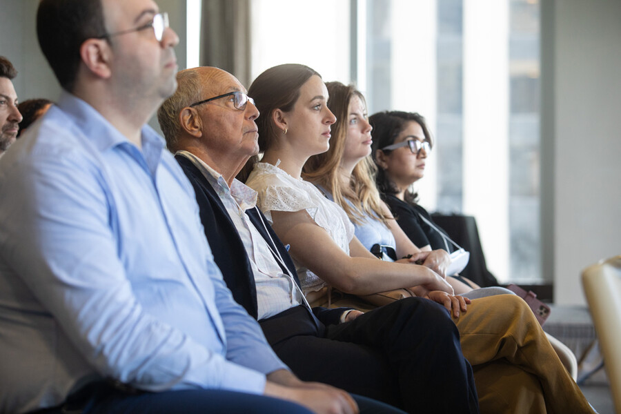 Seated audience members listening
