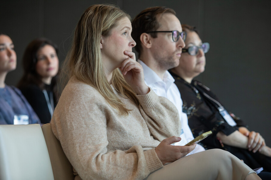 Woman with hand on chin, listening