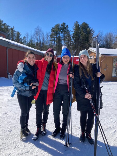 Four residents pose with their skis and snowshoes