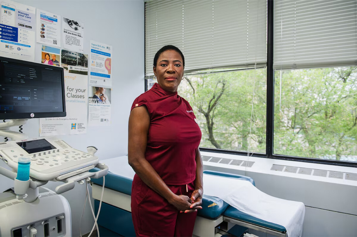 Dr. Tunde-Byass in hospital room standing before empty bed