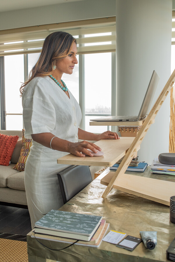 Dr. Roopan Gill works at a standing desk